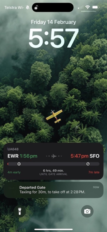 TravelDocs live flight status on an iPhone lock screen, showing a flight that has departed the gate